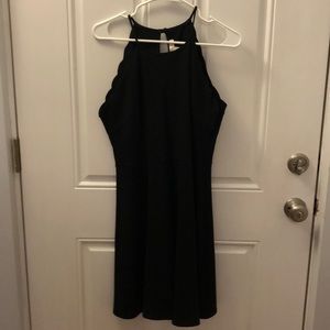 black dress with scalloping detail